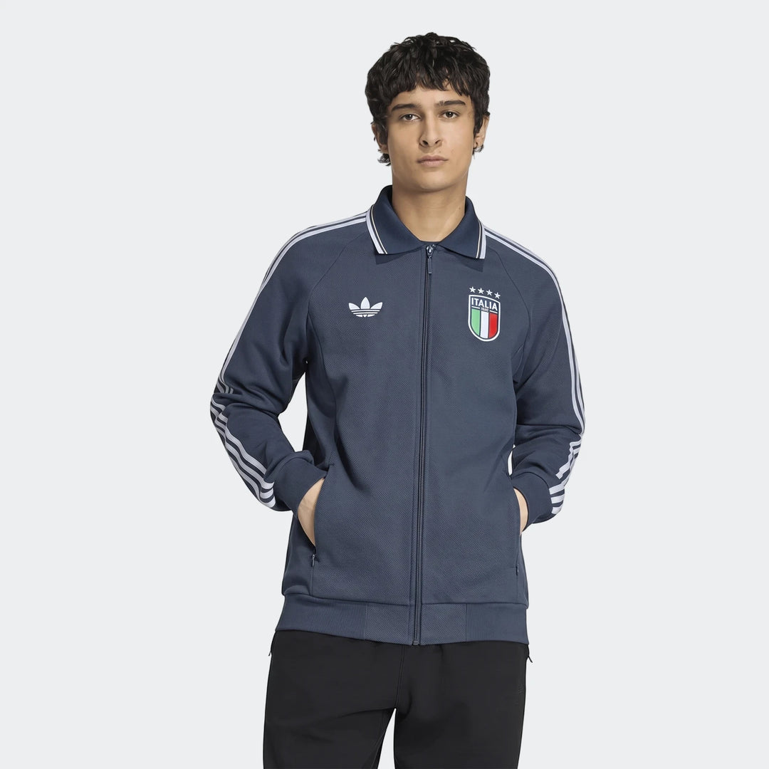 Dark blue Adidas Italy Away Anthem Jacket on a male model, featuring white three-stripes and official crest.