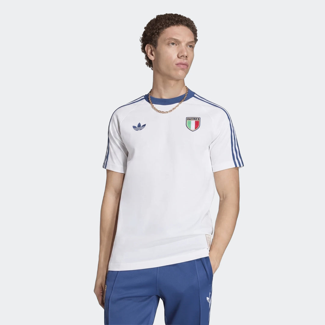 Male model wearing a white Adidas Originals Italy Graphic T-Shirt with blue stripes and the iconic Italia crest. Casual fit