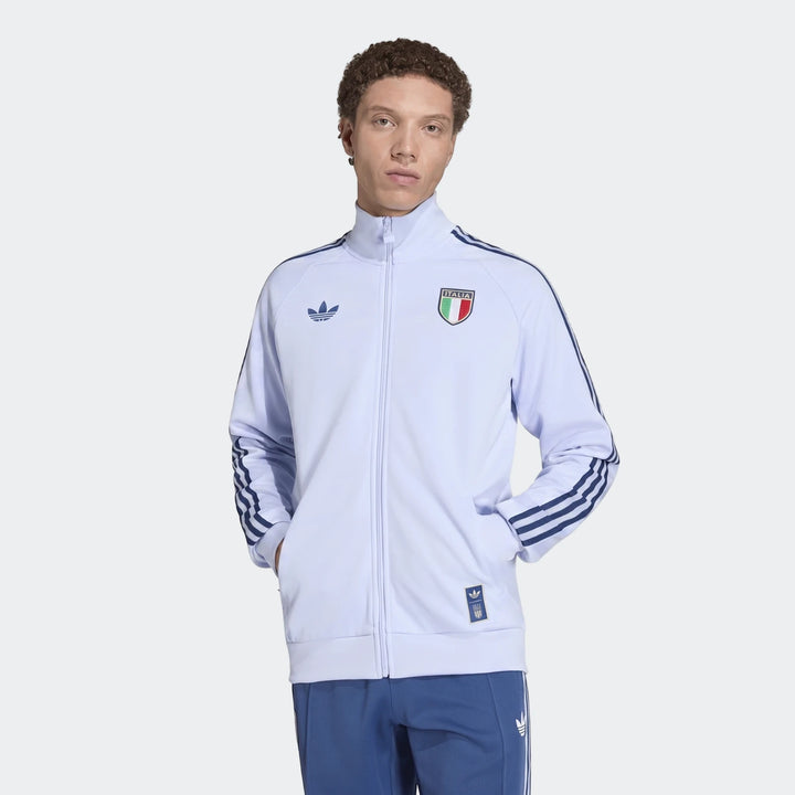 Light blue Adidas Italy Originals Track Top worn by a male model, featuring three stripes on the sleeves and the Italia