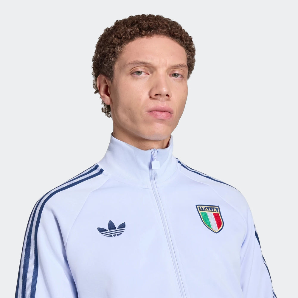 Light blue Adidas Italy Originals Track Top worn by a man, close-up view showing chest and face.