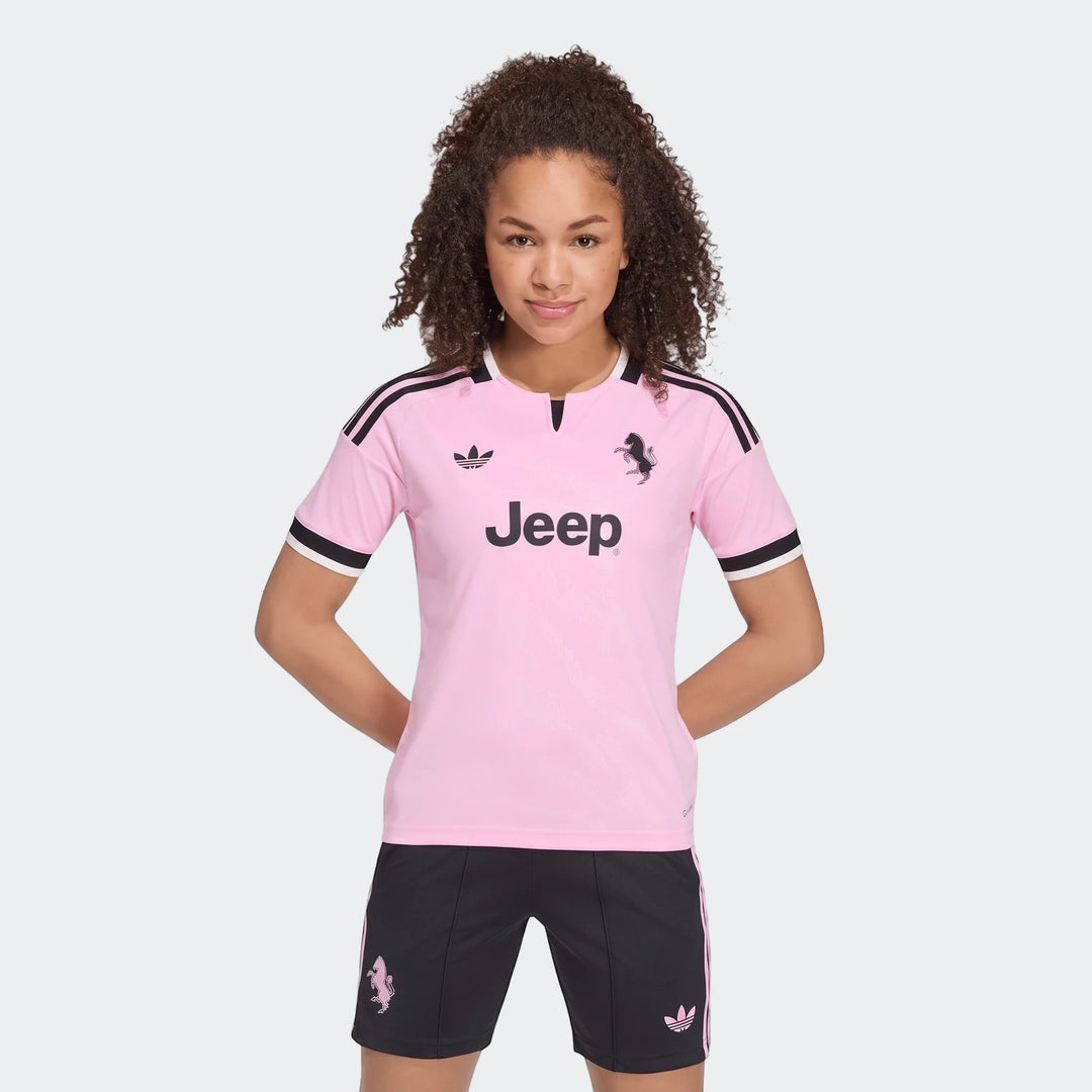 Youth wearing pink and black Adidas Juventus 26/27 Away Jersey and matching shorts, presented in a front view.
