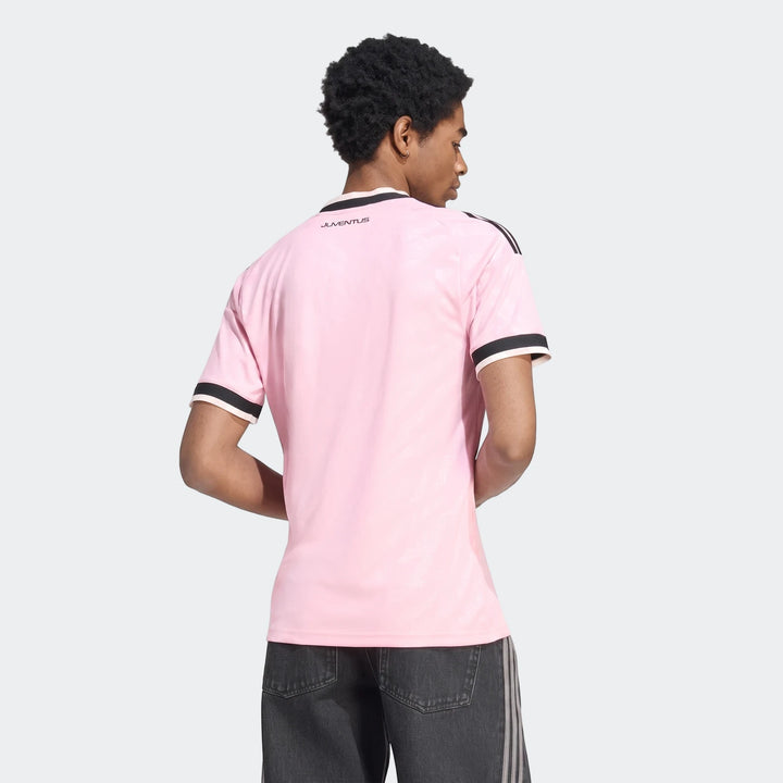 Men's pink Juventus 26/27 Away Jersey, showcasing the back with black and white collar and sleeve trim. Worn by a model.