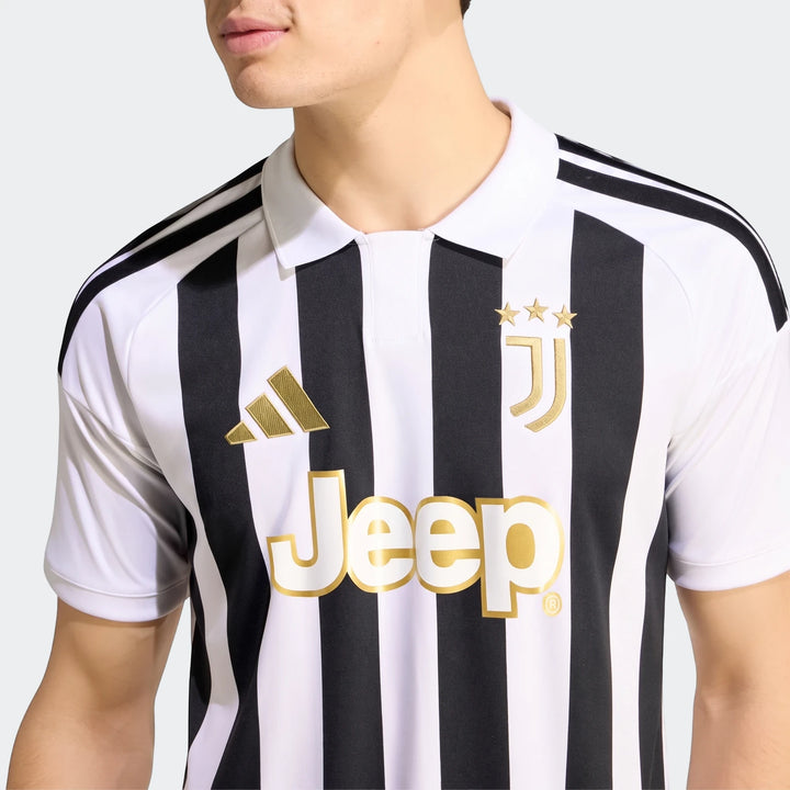 Close-up of a male model wearing the black and white striped Juventus 26/27 Home Jersey with prominent gold Adidas,