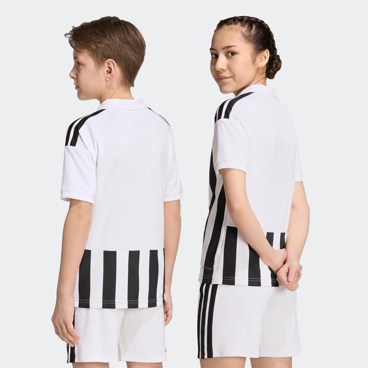 Two children model the Juventus 26/27 Home Jersey Kids and matching shorts, featuring white fabric with black stripes.