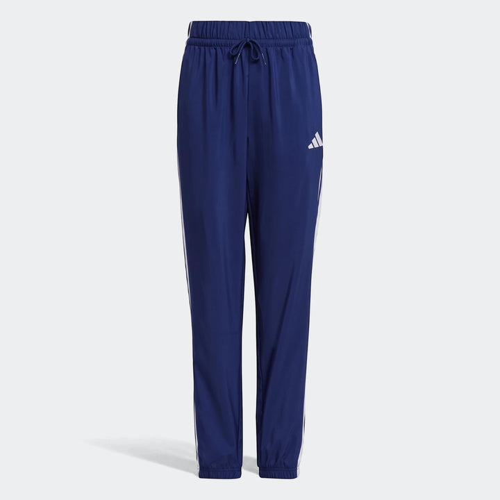 Kids' Adidas Essentials Climacool tracksuit bottoms in navy blue, featuring white side stripes, an elastic drawstring waist,