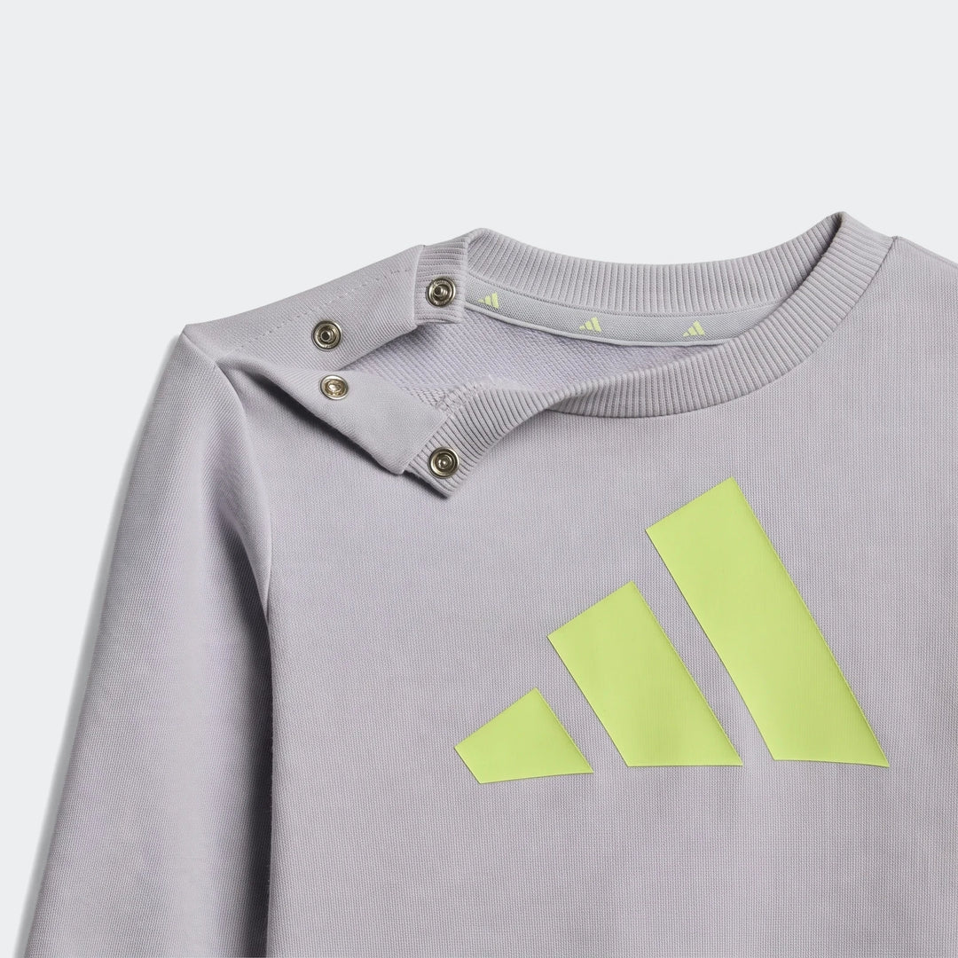 Kids' light grey Adidas Essentials sweatshirt, featuring a vibrant neon yellow three-stripe logo and snap buttons.