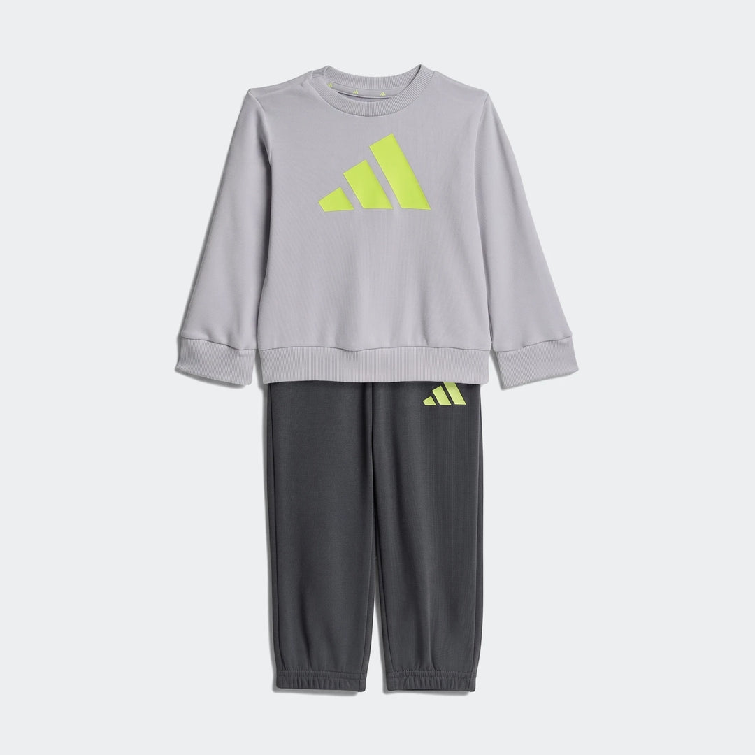 Kids' Adidas Essentials joggers set featuring a light gray sweatshirt with a bold neon yellow logo and dark gray sweatpants,