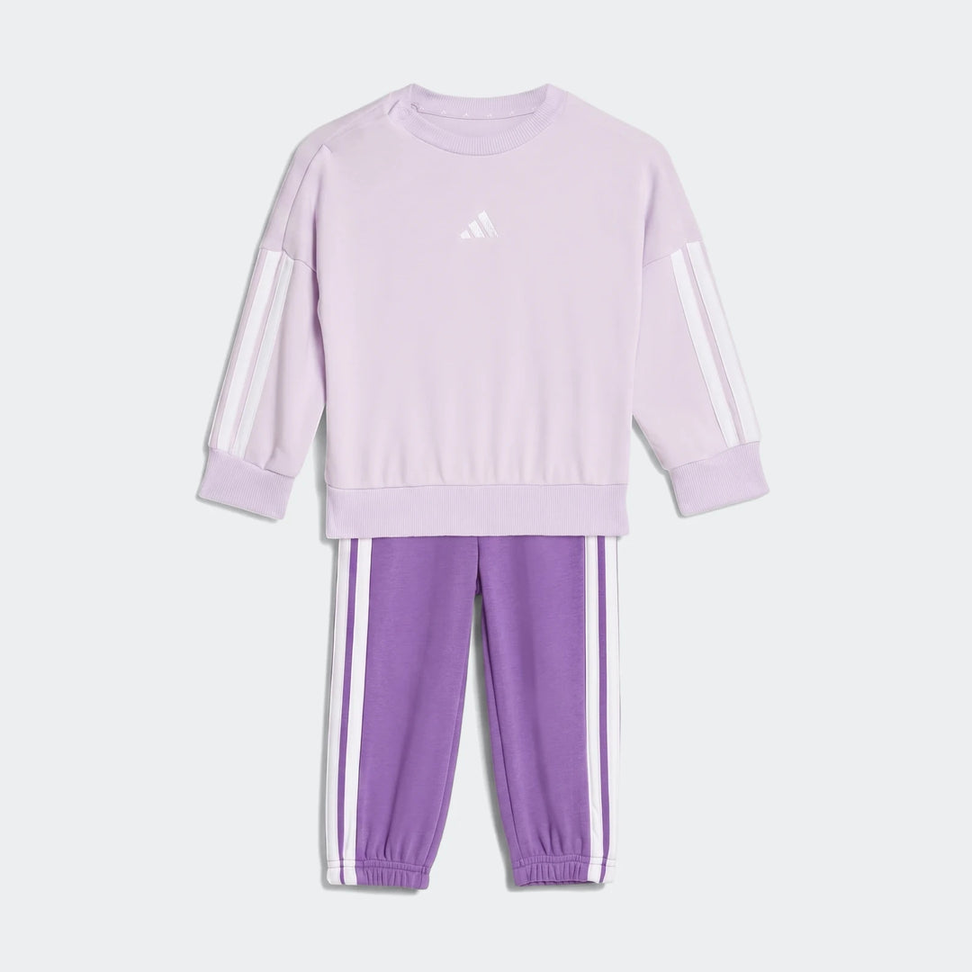 Kids' adidas Essentials joggers set in light lavender and purple, featuring a sweatshirt with white stripes and matching