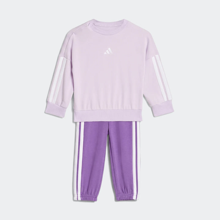 Kids' adidas Essentials joggers set in light lavender and purple, featuring a sweatshirt with white stripes and matching