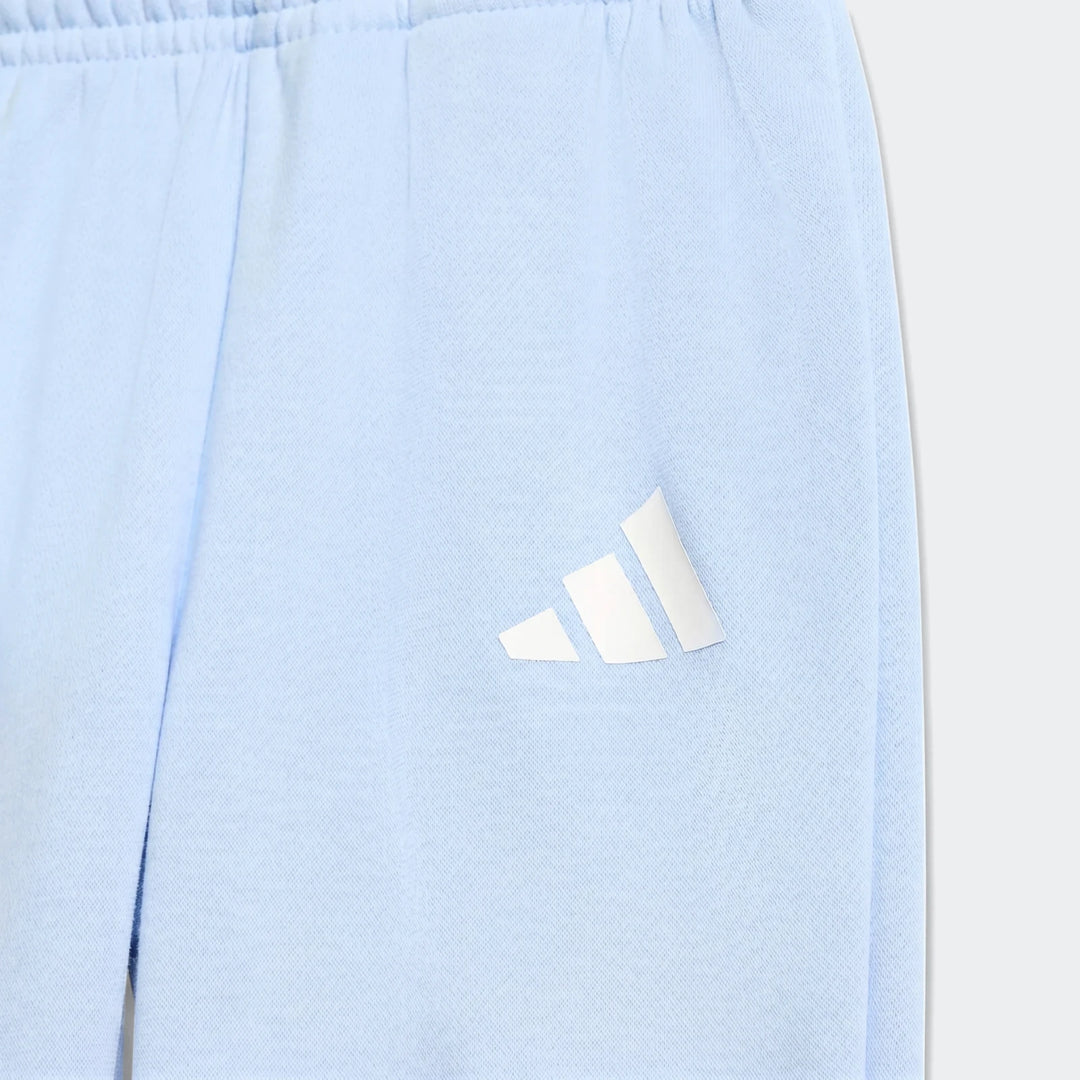 Close-up of Kids' Essentials Joggers in light blue, featuring a white Adidas logo on the thigh.