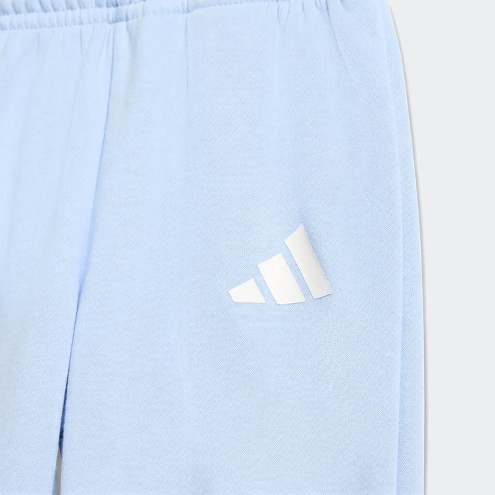 Close-up of Kids' Essentials Joggers in light blue, featuring a white Adidas logo on the thigh.