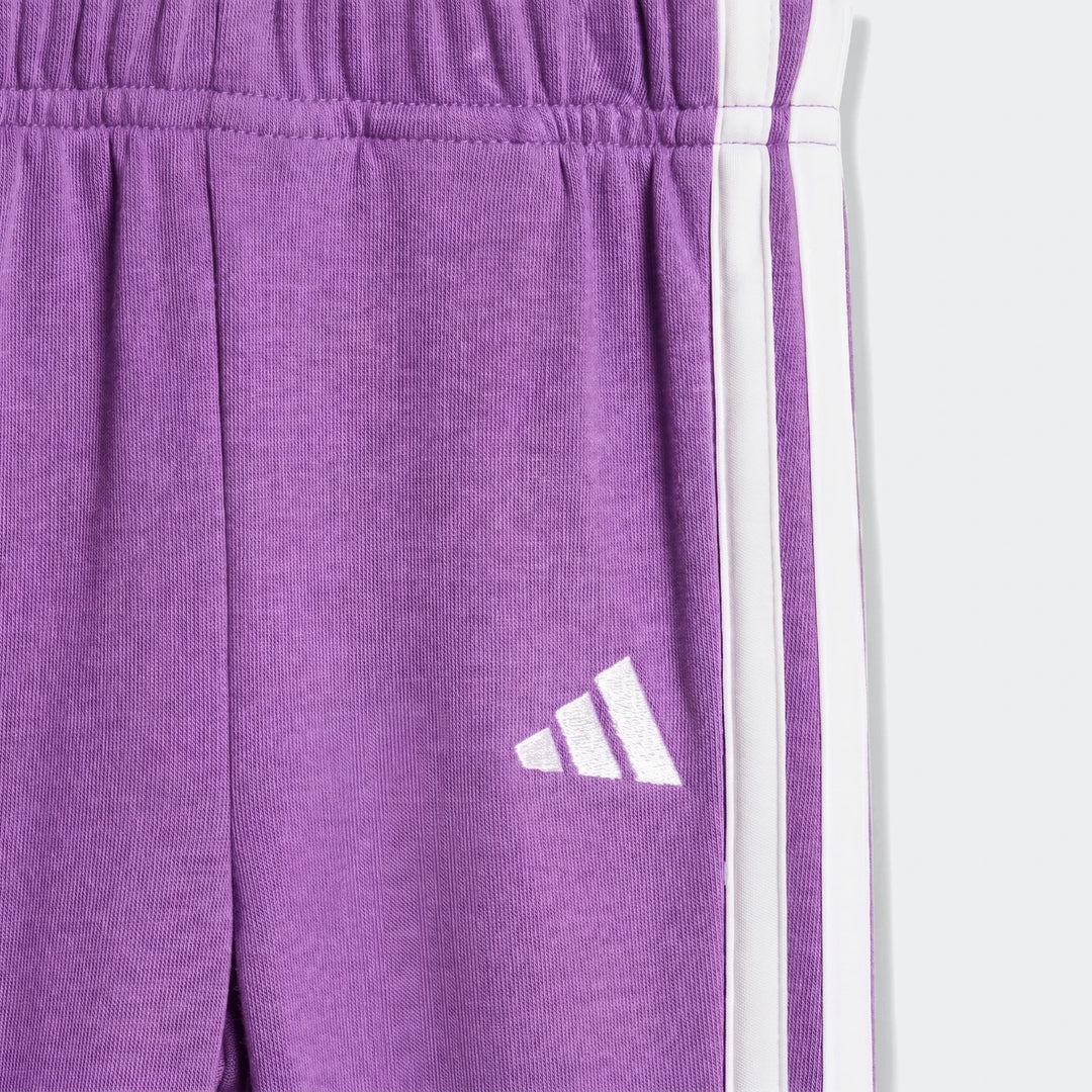 Close-up of kids' Essentials Joggers Set in purple, featuring white side stripes and an embroidered logo.