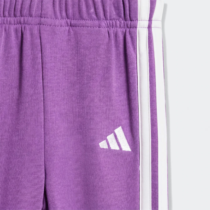 Close-up of kids' Essentials Joggers Set in purple, featuring white side stripes and an embroidered logo.
