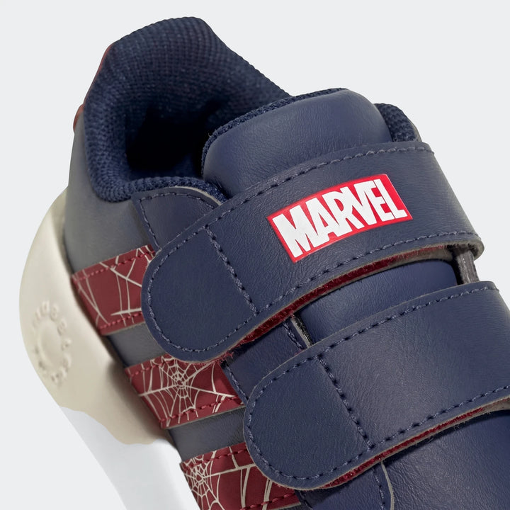 Close-up of kids' navy blue and red Adidas Grand Court Spider-Man Cloudfoam shoes, featuring a Marvel logo and web pattern.