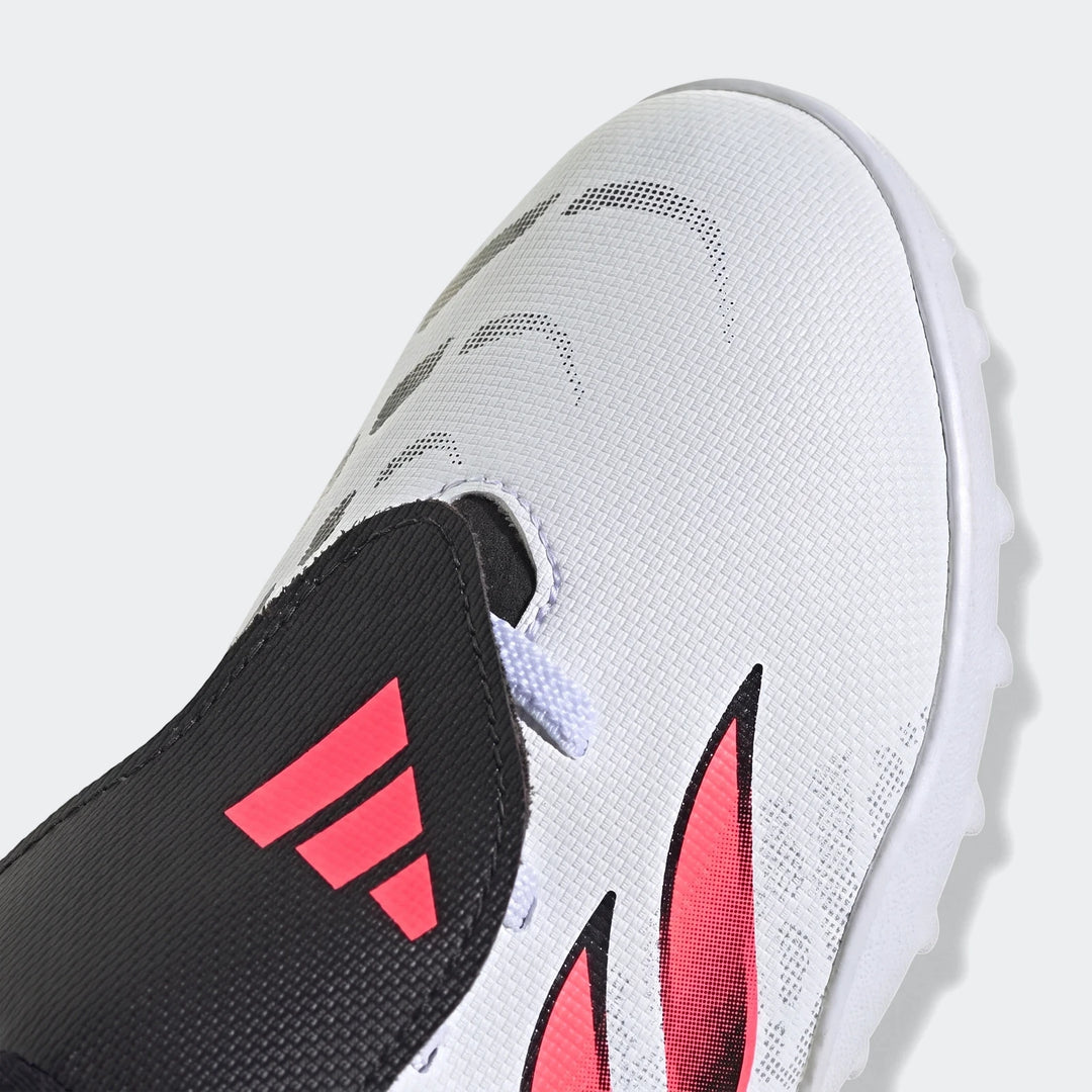Close-up of kids' Predator Club fold-over tongue elastic laces turf football boots in white, black, and pink.