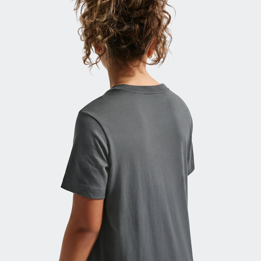 Back view of a person with curly hair wearing a grey Km K Nk Df Mbappe Tee t-shirt.