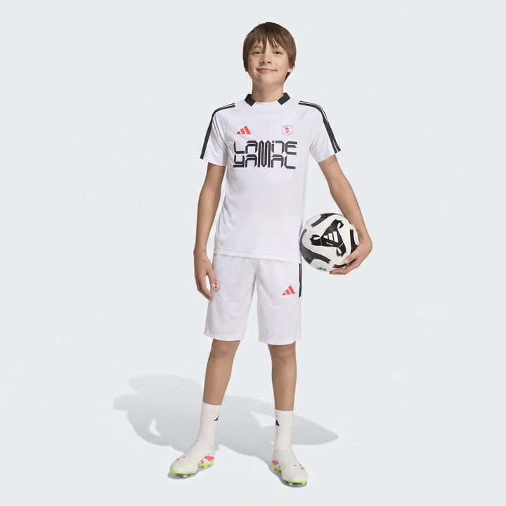 Lamine Yamal Hot Shorts Youth in white, worn by a young boy in a full white soccer kit with matching jersey and cleats,