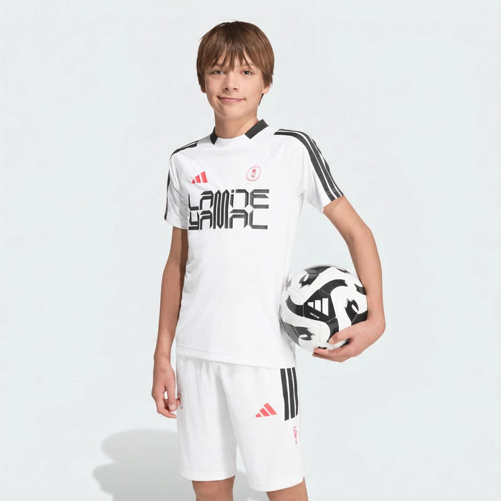 White short-sleeved Lamine Yamal Training T-Shirt for kids, worn by a boy holding a black and white soccer ball.