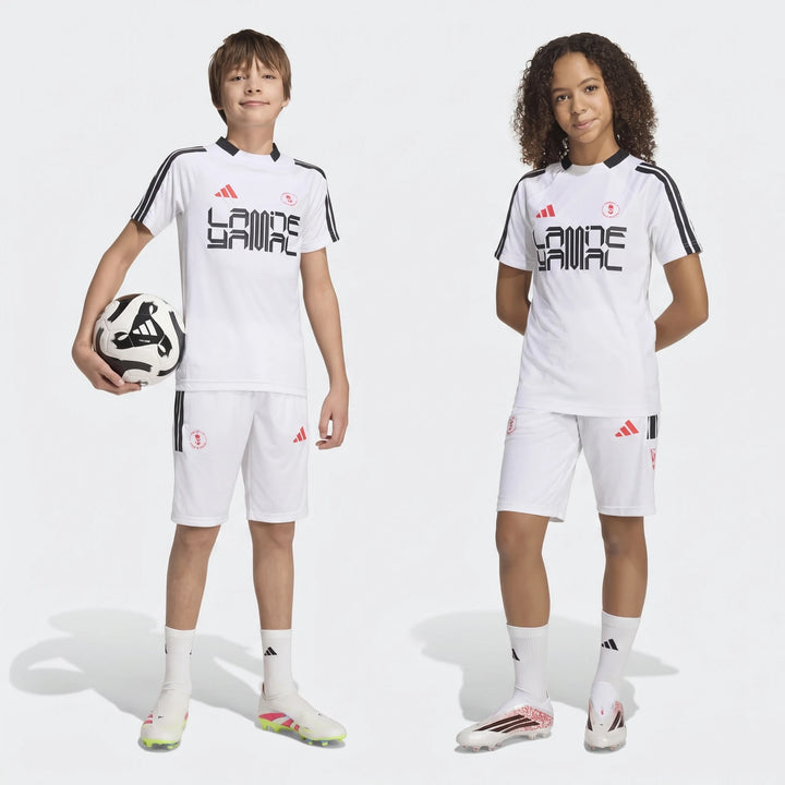 Two young models, a boy and a girl, stand full body in white Lamine Yamal Youth Hot Shorts soccer kits.