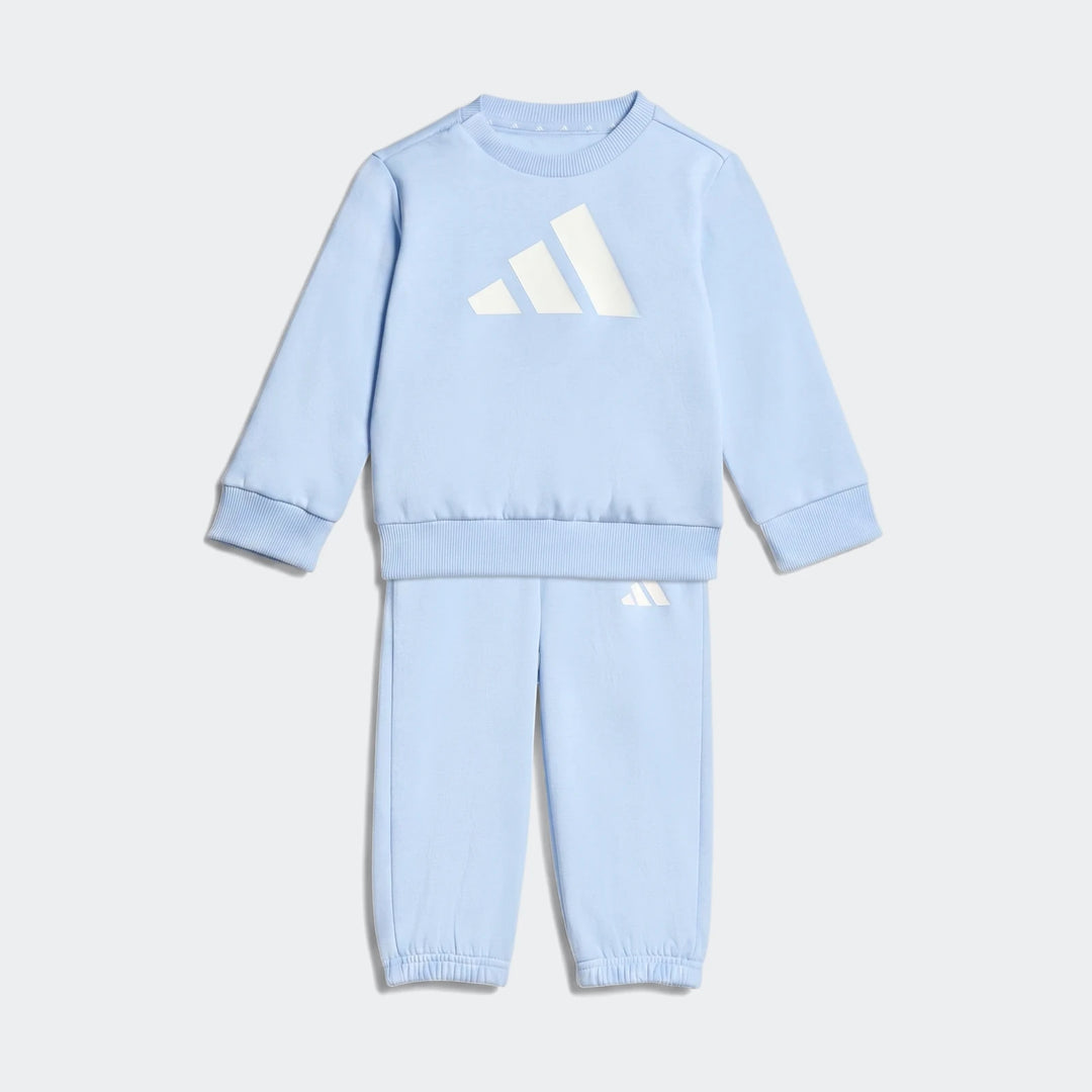 Light blue Adidas Essentials Joggers Kids tracksuit, featuring a sweatshirt and matching joggers, presented laid flat.