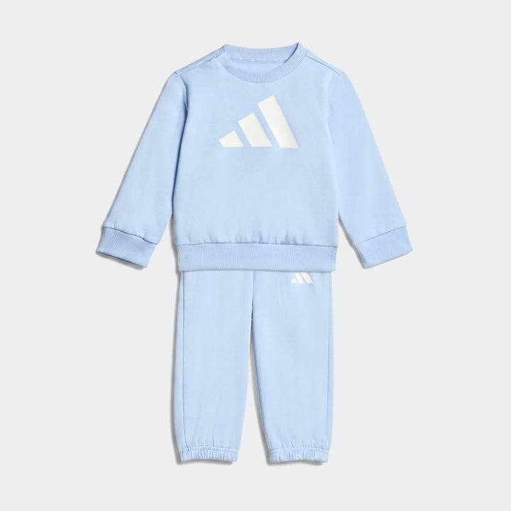 Light blue Adidas Essentials Joggers Kids tracksuit, featuring a sweatshirt and matching joggers, presented laid flat.