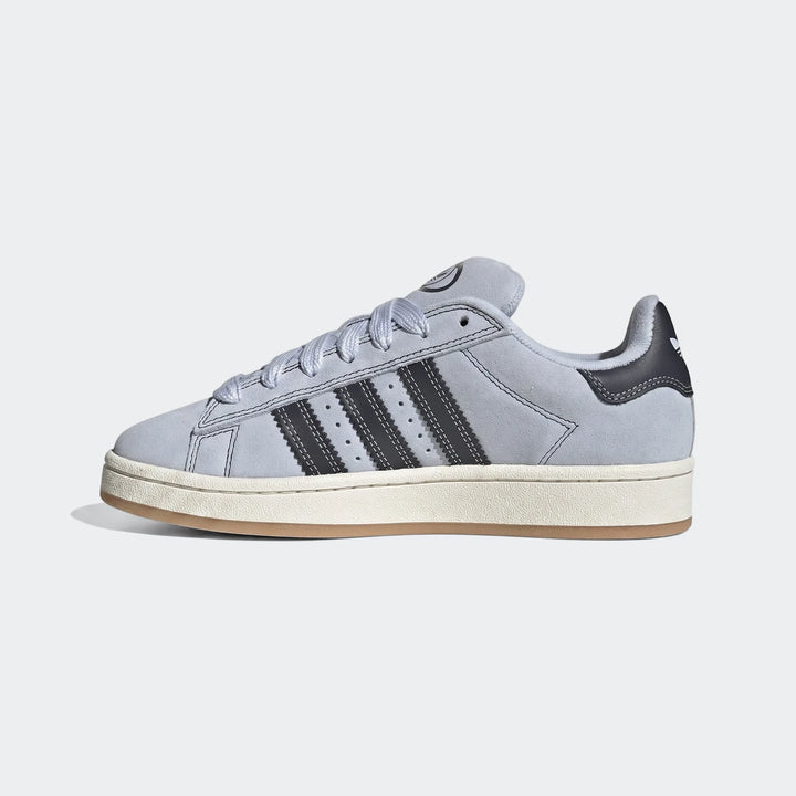 Light blue-grey Adidas Campus 00s suede sneakers, featuring dark stripes and a gum sole, side view.