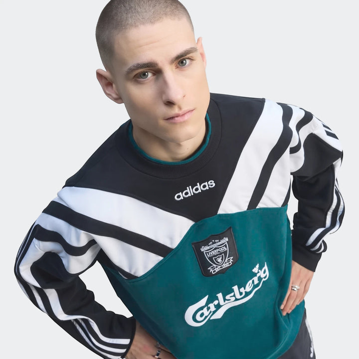Male model wearing a vintage black, white, and teal Liverpool FC 1995 sweatshirt by Adidas, showcasing the long-sleeve