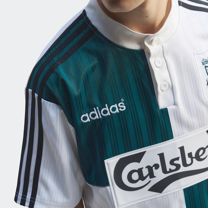 Close-up of a Liverpool FC 1995 Away Jersey in white and dark teal with black Adidas stripes and Carlsberg logo.