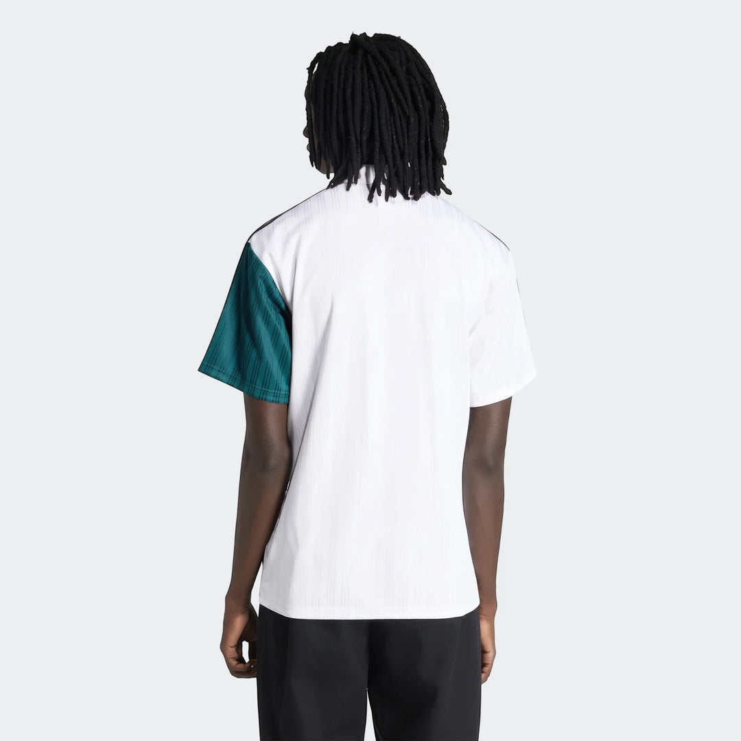 Liverpool Fc 1995 Away Jersey worn by a male model, showing the white and teal short-sleeve shirt from the back.