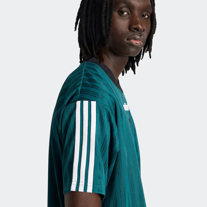 Liverpool Fc 1995 Poly T-Shirt in teal, featuring white Adidas stripes on the sleeve, worn by a model.