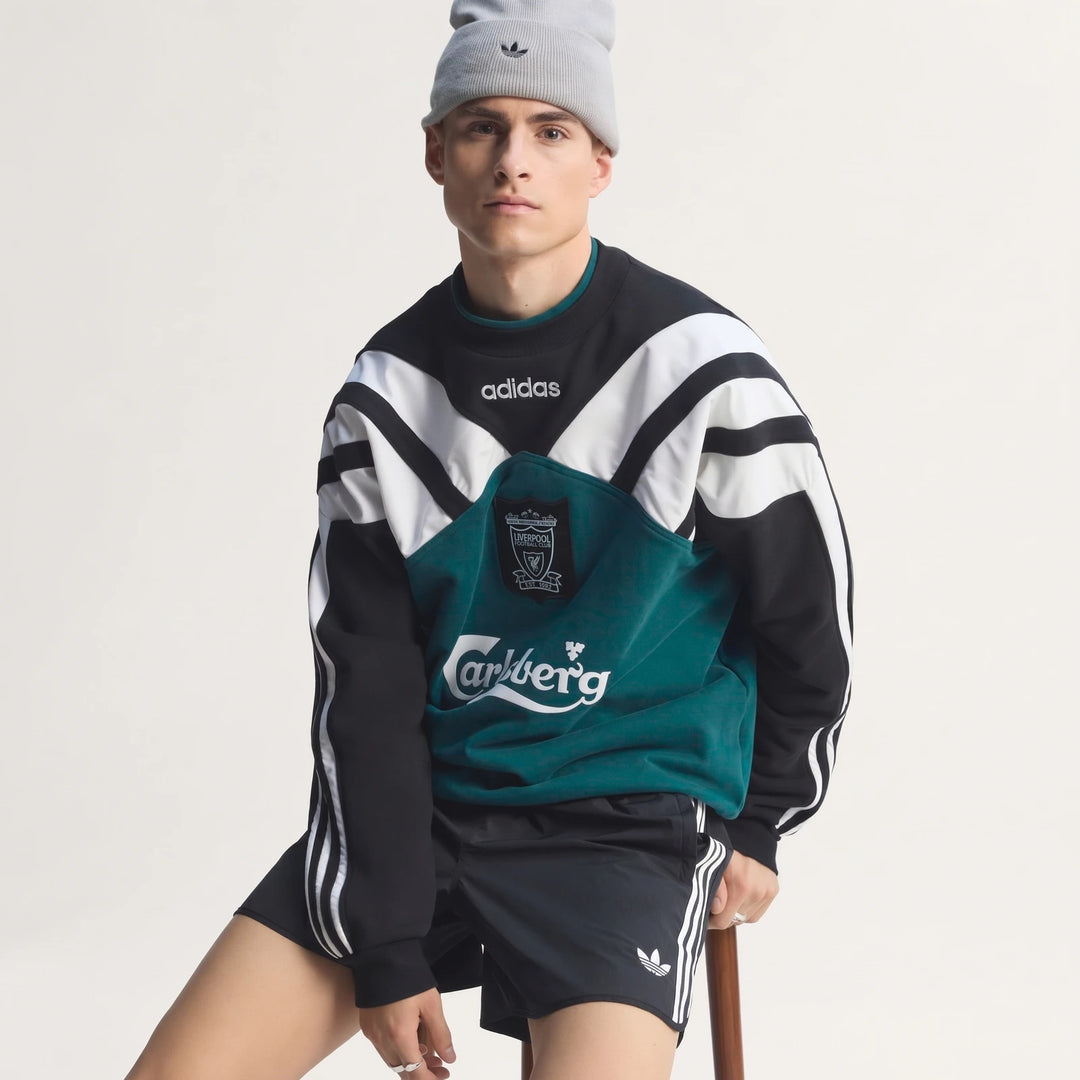 Men's Liverpool Fc 1995 sweatshirt in black, white, and teal with Adidas branding worn by a model.