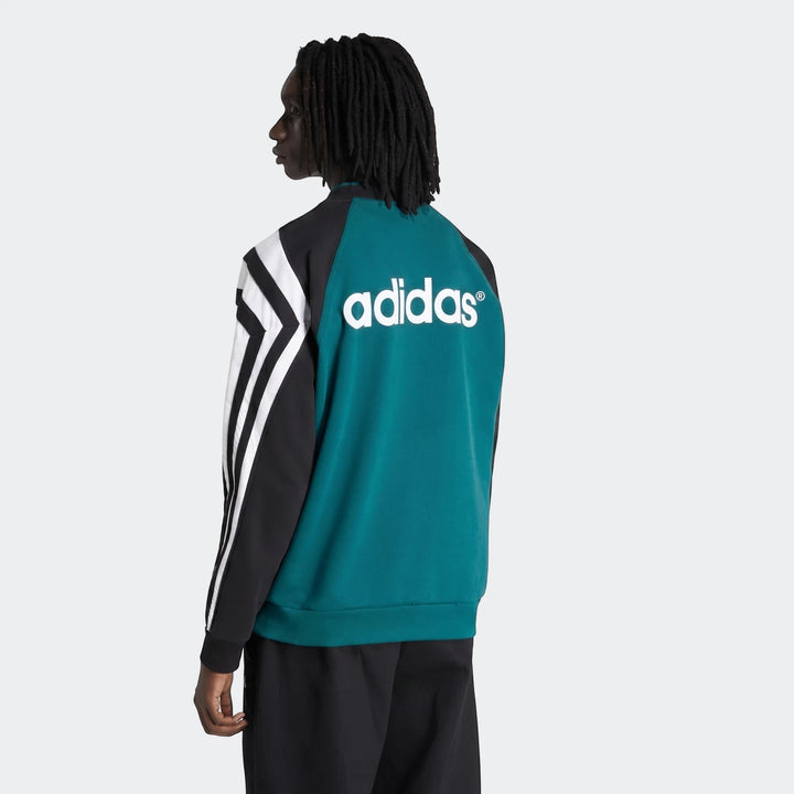 Man wearing a teal and black Liverpool FC 1995 sweatshirt with white Adidas logo on the back, shown from a back view.