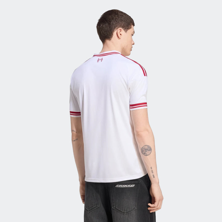 Liverpool Fc 26/27 Away Jersey worn by a male model, displayed from the back-left. The white jersey features red stripes on