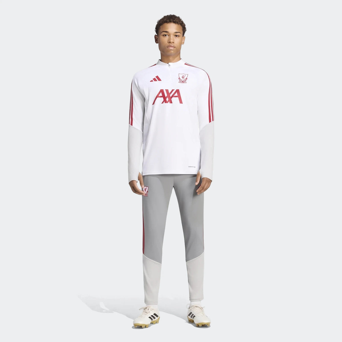 Male model wearing Liverpool FC 26/27 Cup Tiro Training Pants in grey with a matching white long-sleeve top and soccer