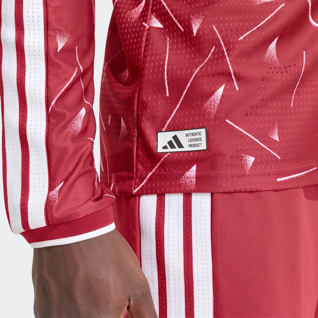 Liverpool FC 26/27 Home Authentic long sleeve jersey close-up in red with white stripes and licensed badge.