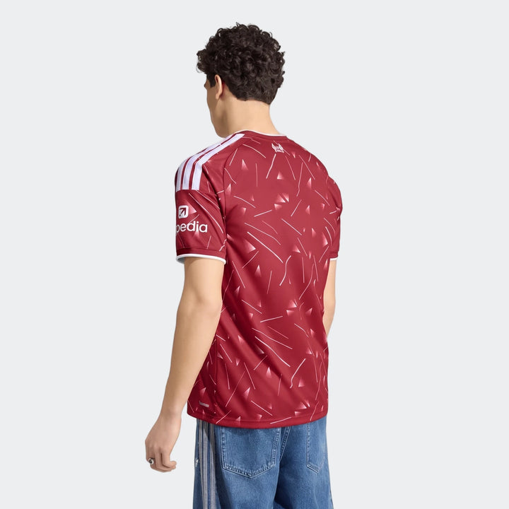 Liverpool FC 26/27 home jersey in deep red with white shoulder stripes, back view showing patterned fabric.