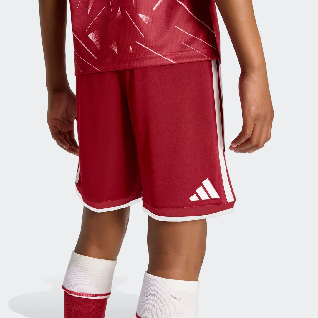 Liverpool FC 26/27 Home Shorts Kids in red with white side stripes and hem trim, shown on model front view.