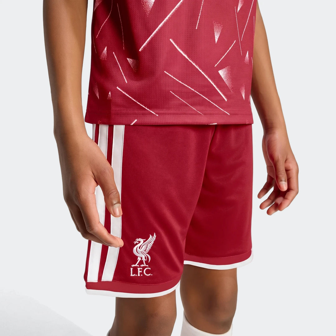 Liverpool FC 26/27 home shorts for kids in red with white side stripes and LFC crest, front view