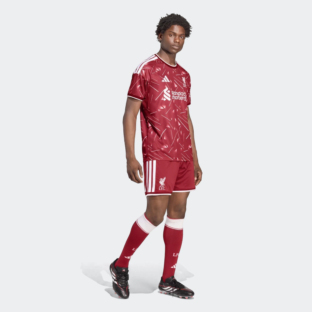 Male model showcasing Liverpool FC 26/27 Home Shorts in maroon and white with club crest, part of the full kit.