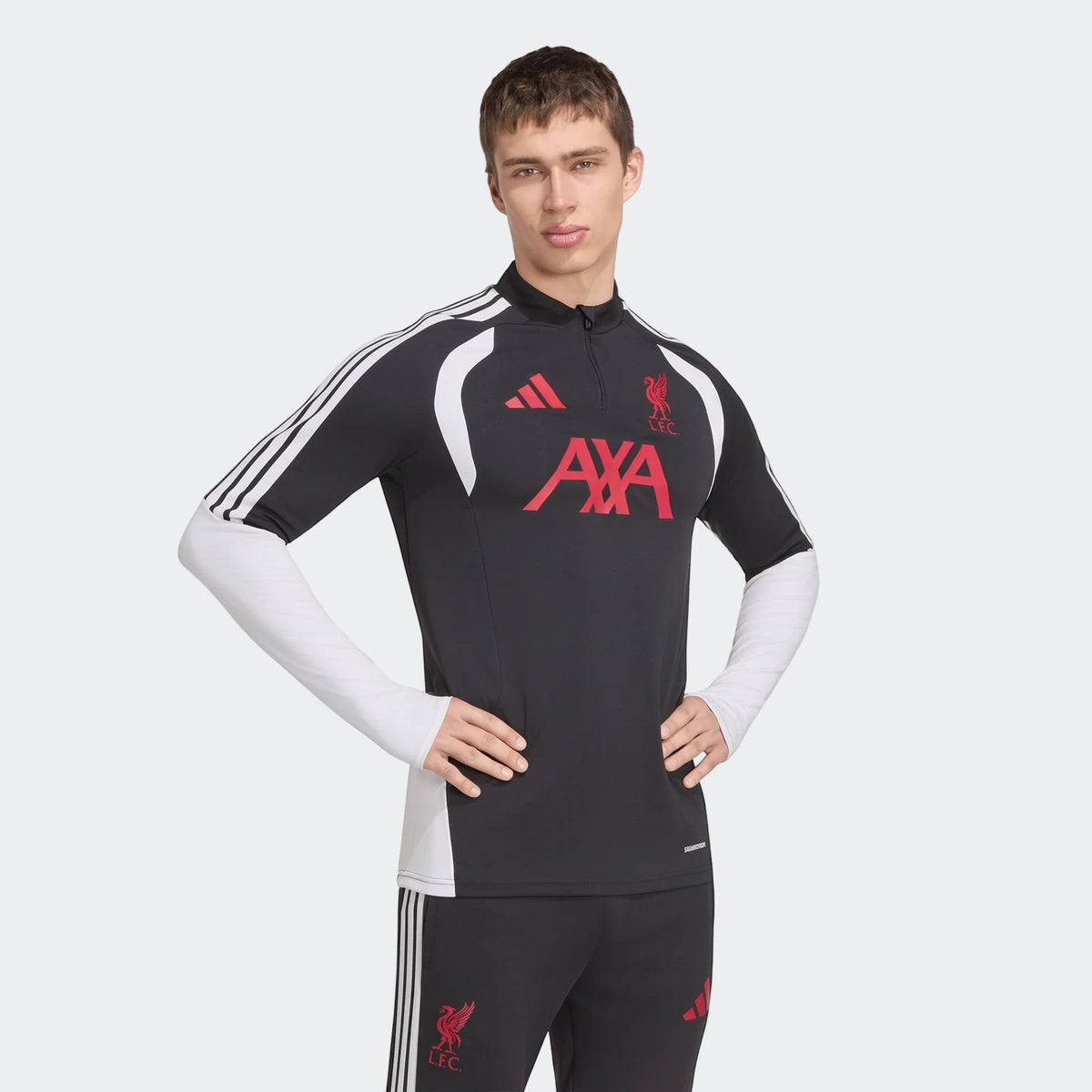 Black and white Adidas Liverpool FC 26/27 Tiro training top with red logos, worn by a male model.