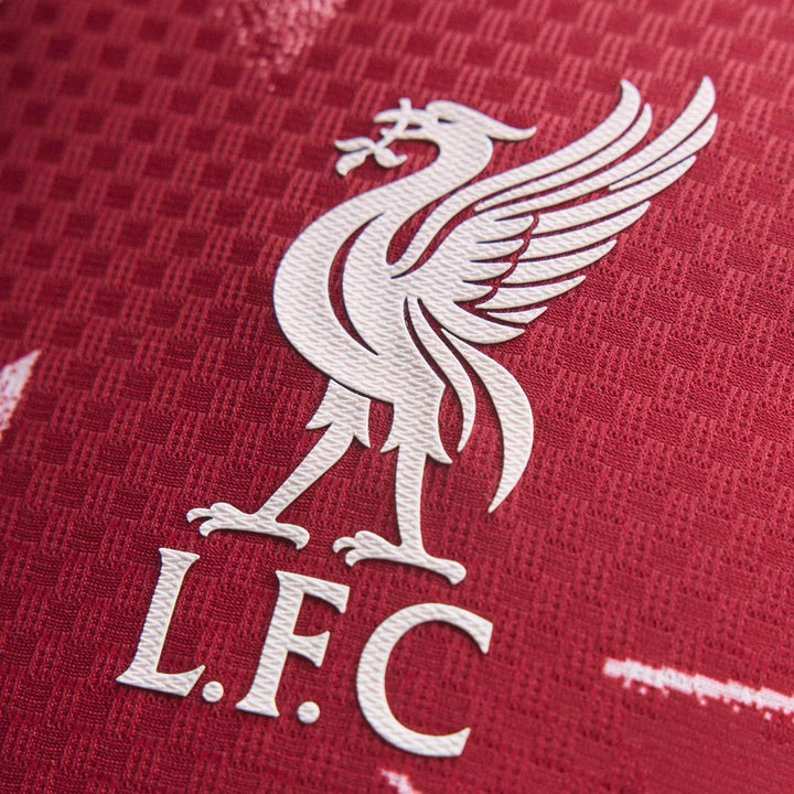 Liverpool FC 26/27 Home Authentic Longsleeve Jersey close-up of white LFC crest on red textured fabric