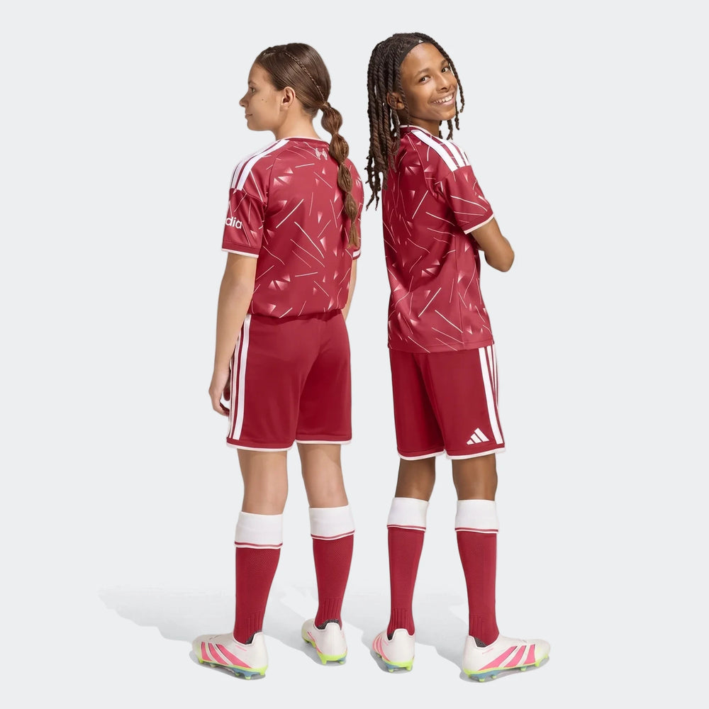Liverpool FC 26/27 home shorts for kids in deep red with white side stripes, shown from the back on youth players.