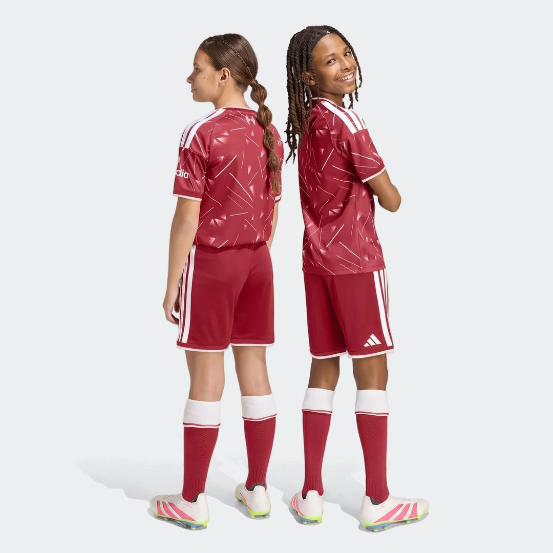 Liverpool FC 26/27 home shorts for kids in deep red with white side stripes, shown from the back on youth players.