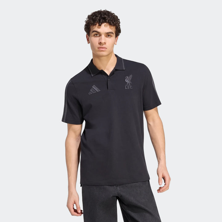 Men's black Adidas Liverpool FC DNA short-sleeve polo shirt with club crest and Adidas logo, worn by a model.