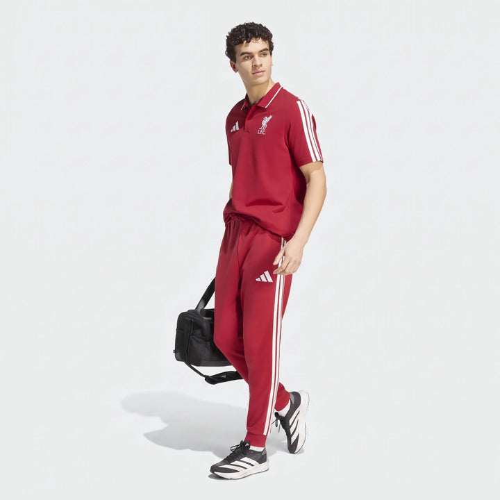 Liverpool FC DNA polo shirt in red with white crest and three-stripe detailing on sleeves.