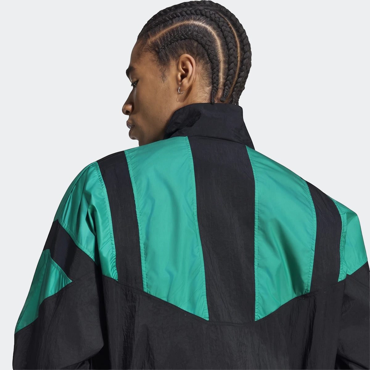 Back view of a man wearing a black and green striped Liverpool Fc Eqt Track Top, showcasing the unique design.