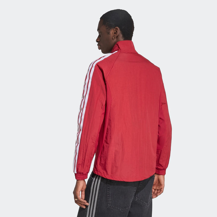 Male model wearing a red Liverpool FC Home Anthem Jacket with white and red striped sleeves, seen from the back.