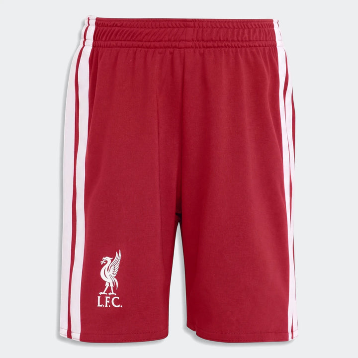 Red Liverpool FC kids' home sports shorts featuring white side stripes and the club crest logo, laid flat from a top-down
