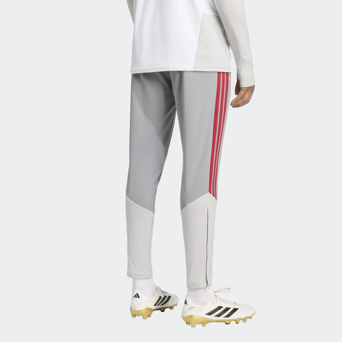 Rear view of gray Adidas Liverpool FC 26/27 Cup Tiro Training Pants with red stripes, worn by a person, paired with white