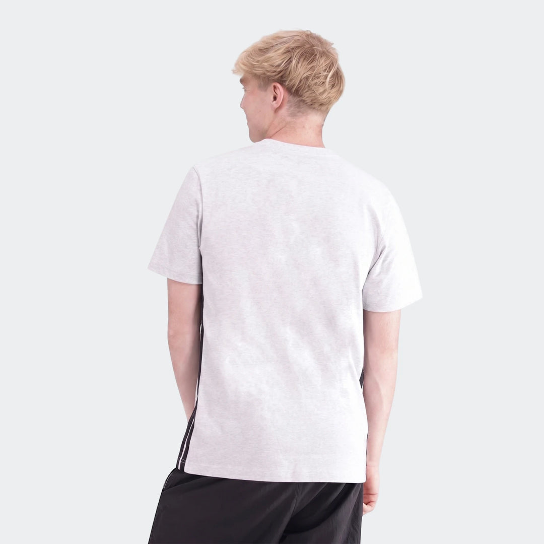 Male model wearing a light grey melange 3-Stripes Single Jersey T-Shirt and black shorts, captured from the back.